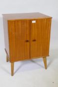 A mid century 'Arnold' sapele wood record cabinet, the interior fitted with drop down record holders