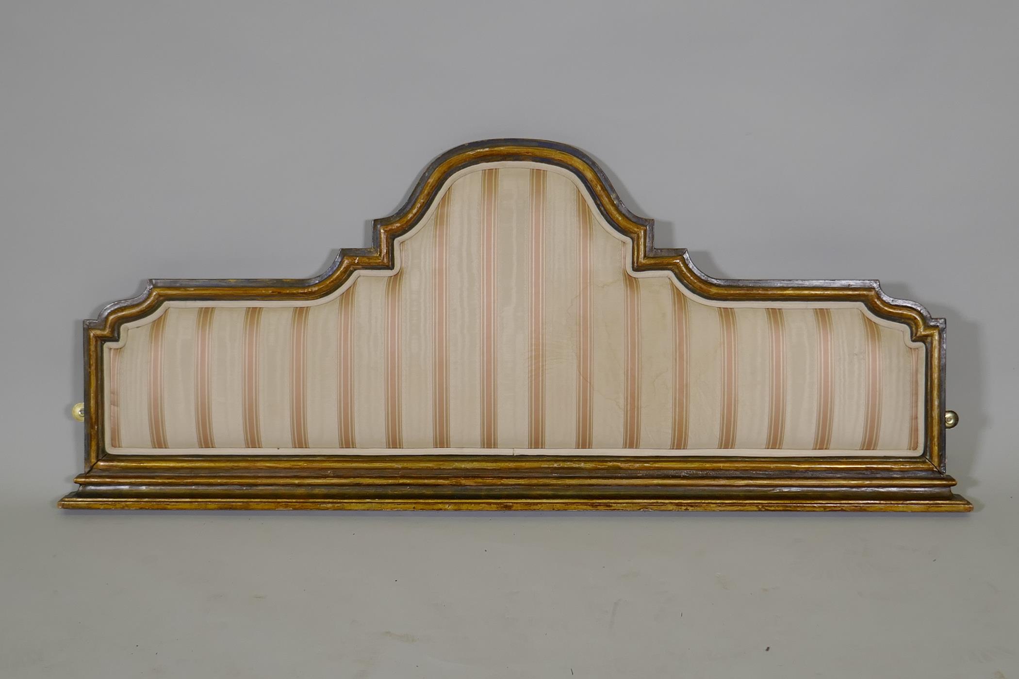 A painted and parcel gilt bed head/panel, with inset silk, 47" x 19"