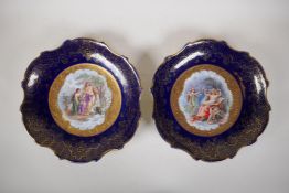 A pair of Vienna porcelain blue ground cabinet dishes, with gilt shaped rims and transfer printed