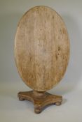 A walnut oval top pedestal loo table, on tubular column and quatrefoil base, 29½" x 46" x 33"
