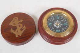 A nautical themed compass in brass inlaid hardwood box, 3" diameter