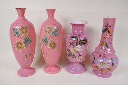 A pair of C19th pink milk glass vases, painted with flowers, 12½" high, 1AF, and two other similar