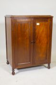 An Edwardian mahogany record cabinet with fitted interior, raised on turned supports, 18" x 24" x