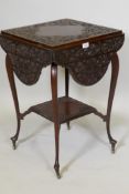 A Victorian mahogany two tier occasional table with four shaped flaps and all over chip carved