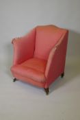 A Victorian upholstered parlour armchair on swept square supports