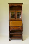 A Victorian inlaid mahogany bureau bookcase, the upper section with pierced frieze and open shelf