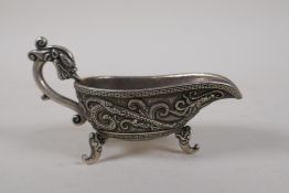 A Chinese white metal libation cup with raised dragon decoration, mark to base, 5½" long