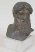 A bronze bust of a classical philosopher, mounted on a square socle, 5" high