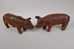 A pair of cast iron garden piglets, 12" long