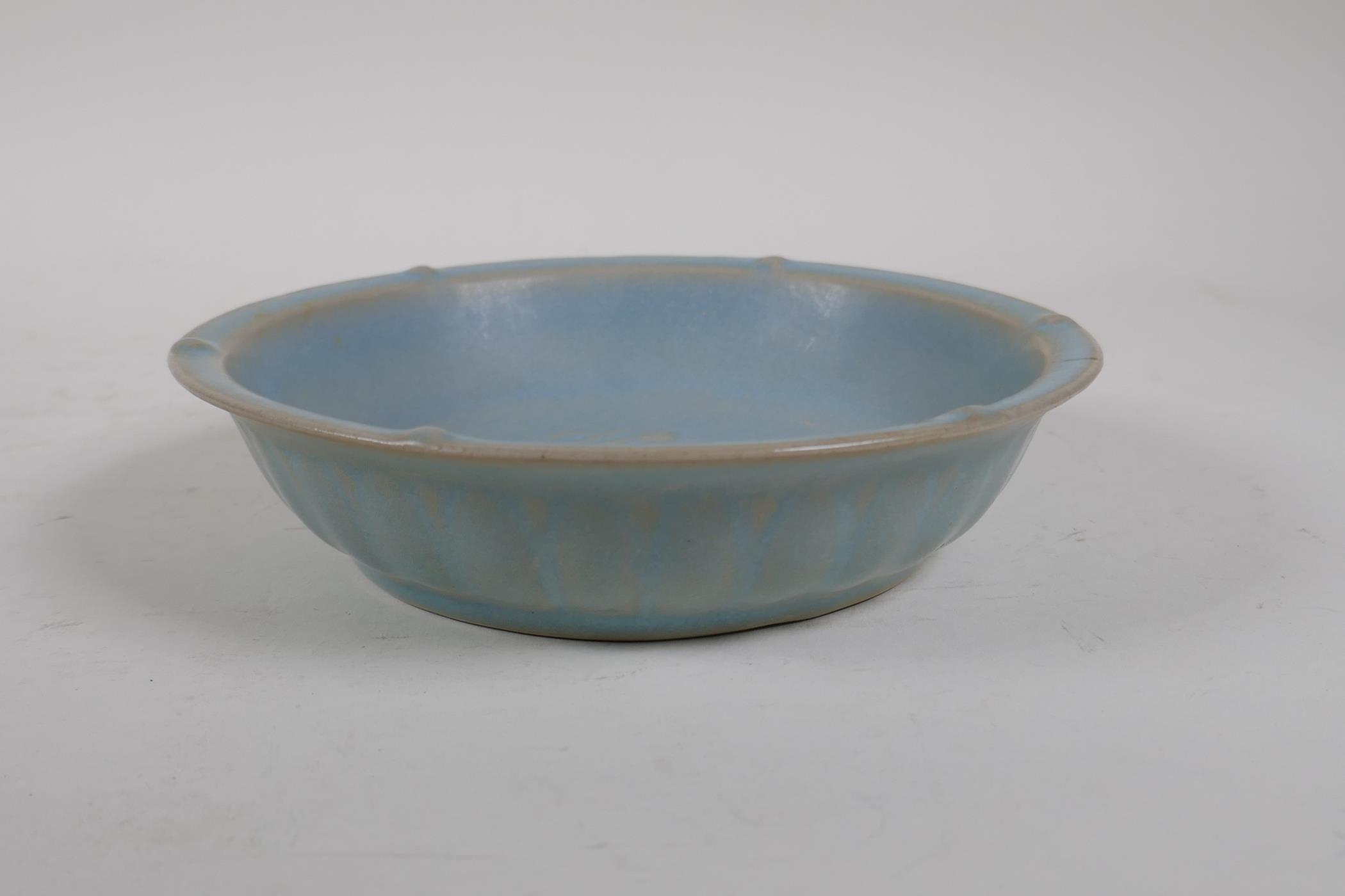 A Chinese Ru ware style porcelain dish with raised dragon decoration to the bowl, chased and gilt