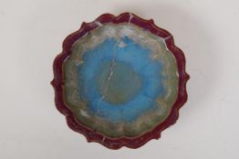 A Chinese jun ware pottery dish on tripod supports with lobed rim, AF repair, 7½" diameter