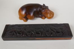 An African hardwood Bao Mancala board carved with rhinos, 13" long, and an African carved hardwood