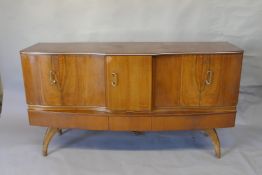 A mid century Beautility walnut sideboard, with a cupboard opening to reveal a cocktail cabinet with