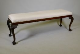 A Chippendale style mahogany window seat, raised on carved cabriole supports with claw and ball