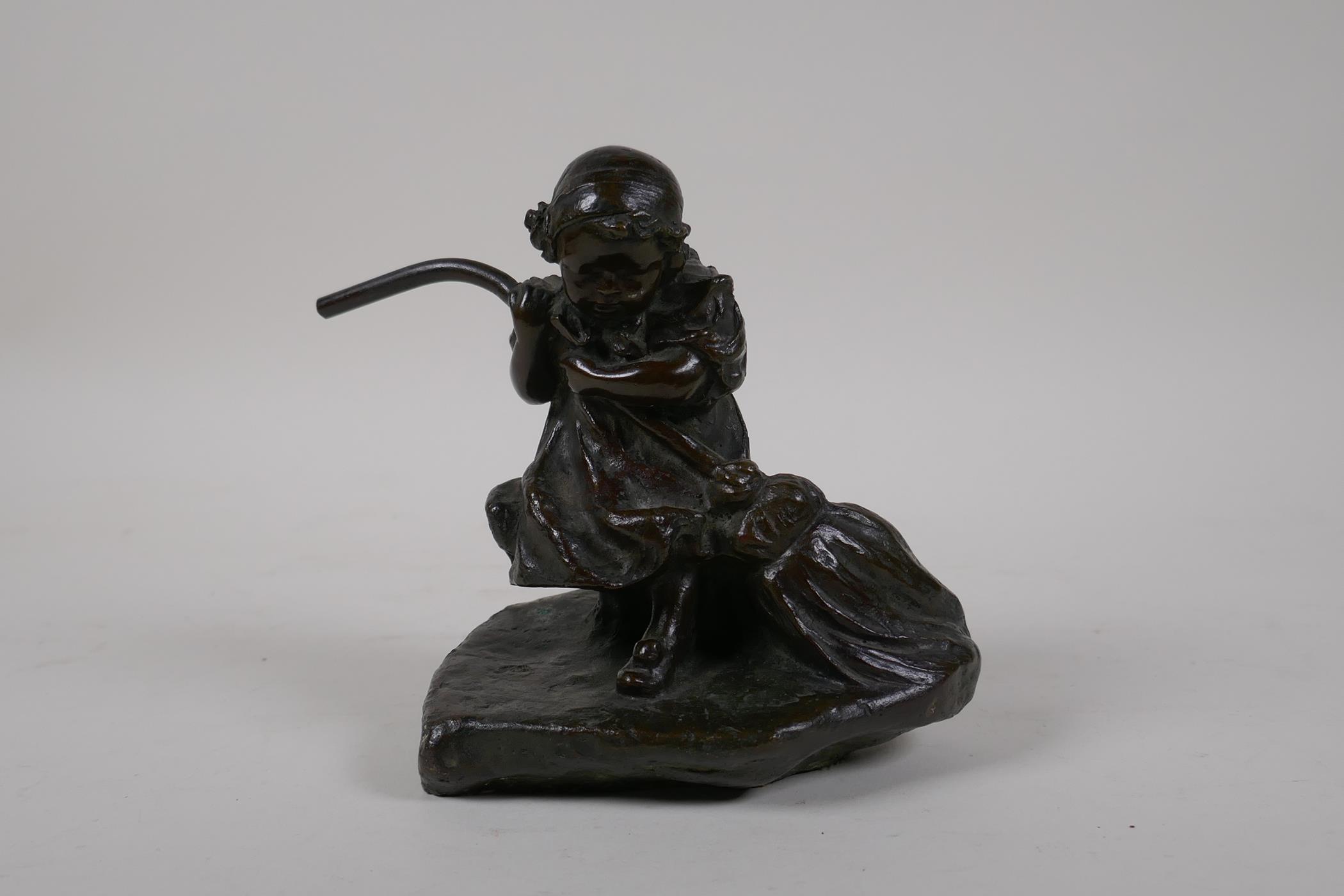 An Italian bronze figure of a young girl sweeping, signed E. Simone (Edgardo Simone), stamped '