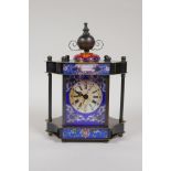 A brass cased mantel clock, decorated with printed enamel panels and a cloisonne knop, 8" high