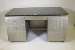 A mid C20th brushed steel industrial style kneehole desk with rubberised top, fitted with five