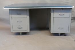 A mid century industrial style metal pedestal desk, with chromed cup corners, fitted with five