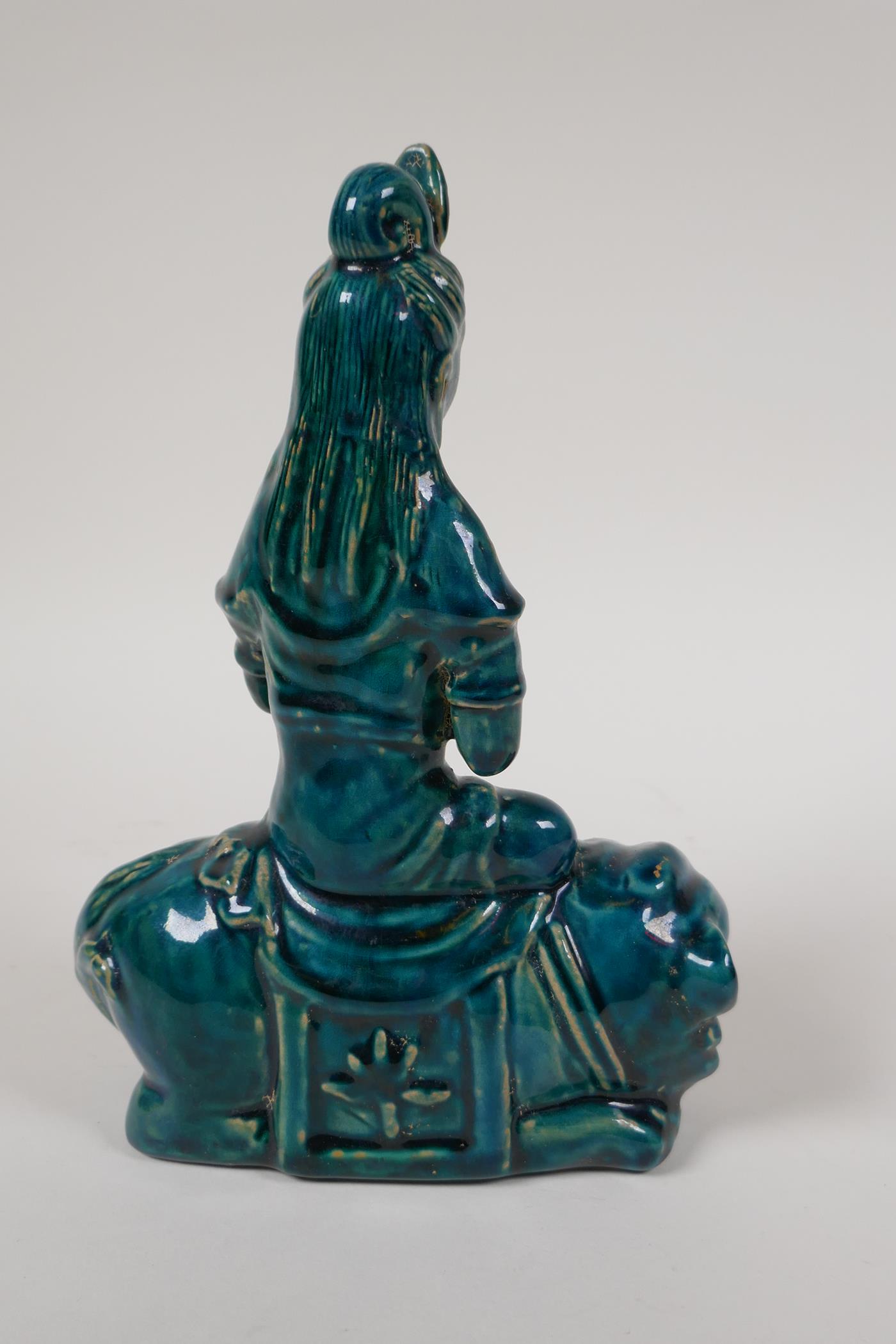 An emerald glazed porcelain Quanyin seated on a kylin, 8½" - Image 2 of 3