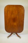 A Regency mahogany tilt top breakfast table, raised on a turned column and splay supports, 37" x 53"