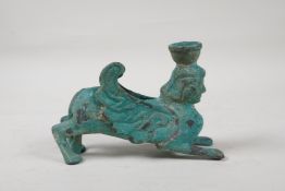An antique bronze candlestick in the form of a Harpy, with verdigris patina, 5½" long