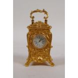 A gilt brass miniature carriage clock in the rococo style, 3" high