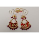 A pair of Indian gilt metal drop earrings with  semi precious red stone drops and enamelled