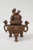 A Chinese iron censer and cover with two dragon handles, tripod dragon mask supports and a kylin