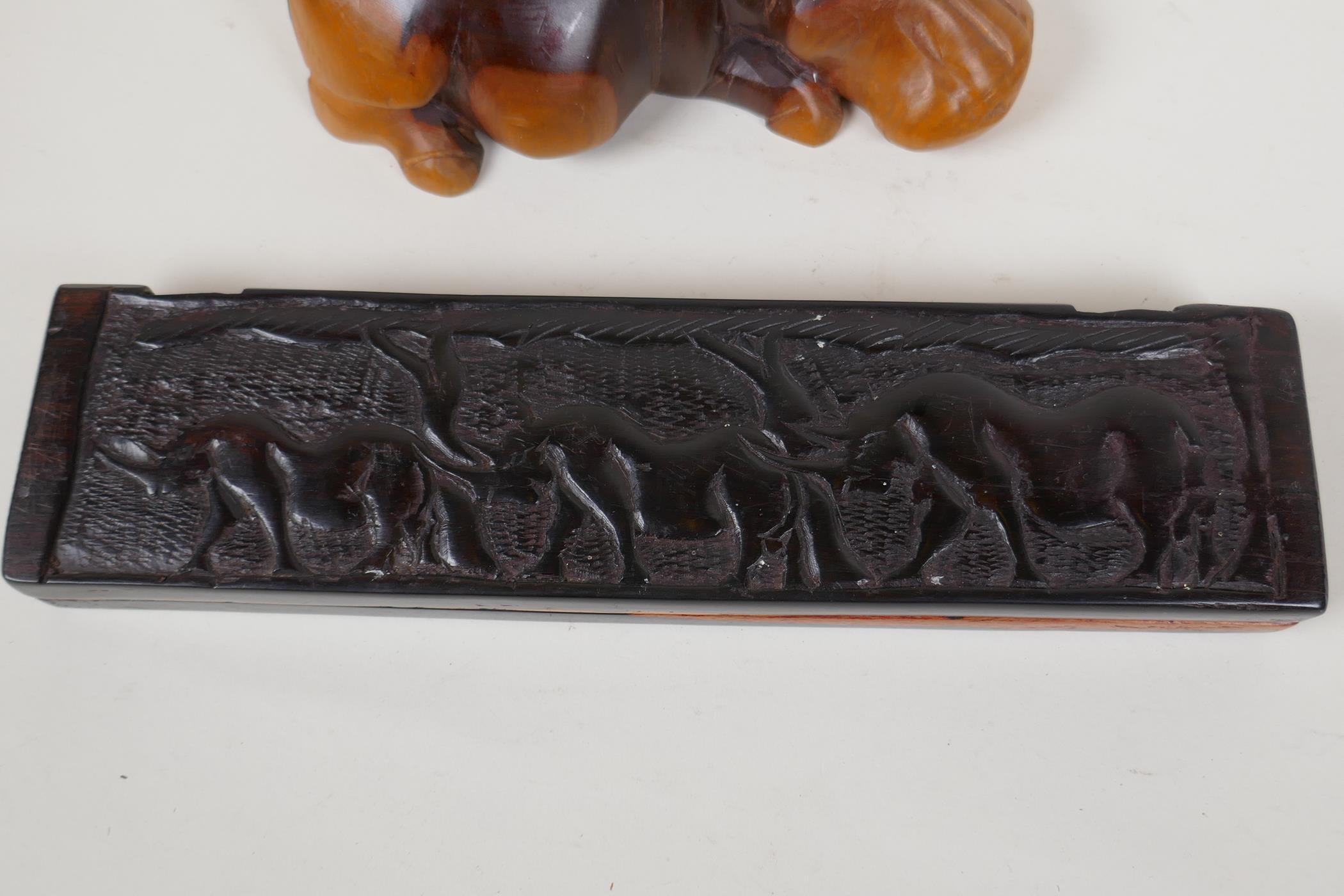 An African hardwood Bao Mancala board carved with rhinos, 13" long, and an African carved hardwood - Image 3 of 5