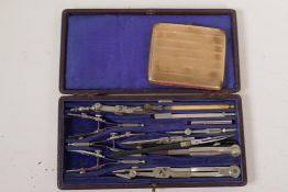 A cased technical drawing set and a silver plated cigarette box