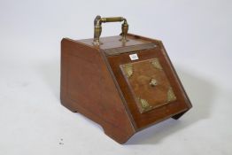 A Victorian walnut coat scuttle with brass mounts and handle, complete with shovel and metal