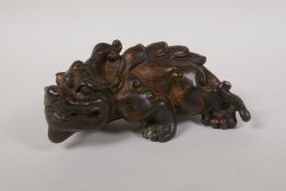 A Chinese filled bronze kylin with gilt patina, 7½" long