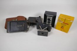 A Kodak Brownie Reflex camera in original box, an Actus Ansco Vest pocket camera and a Kodak