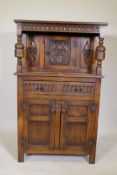 A small Reprodux of Brighton oak court cupboard, with carved frieze and decoration, single drawer