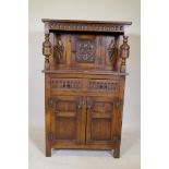 A small Reprodux of Brighton oak court cupboard, with carved frieze and decoration, single drawer