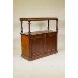 A C19th mahogany two tier buffet, the top with three quarter gallery and raised on turned