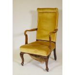 A Victorian open arm walnut armchair, with high back and scroll arms, raised on cabriole supports