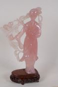 A carved rose quartz figure of a Chinese lady, on a hardwood stand, 8" high