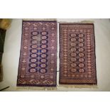 A Turkish blue ground Bokhara rug, a similar black ground Bokhara rug and two others, largest 68"