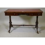 A Victorian figured walnut two drawer writing table, with leather inset top and open fretwork