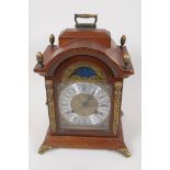 A French walnut cased bracket clock with striking movement and moonphase in brass embellished