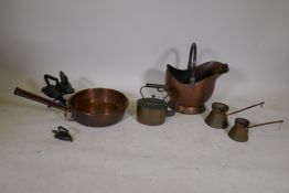 A C19th copper pan with a historic repair, a copper kettle, two copper milk measures, a copper