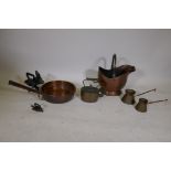 A C19th copper pan with a historic repair, a copper kettle, two copper milk measures, a copper