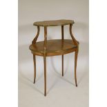 A C19th satinwood two tier occasional table, with cross banded tops, brass mounts and shaped top,