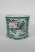 A famille vert porcelain brush pot decorated with birds amongst flowers and figures in a