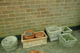 A quantity of terracotta and concrete garden pots