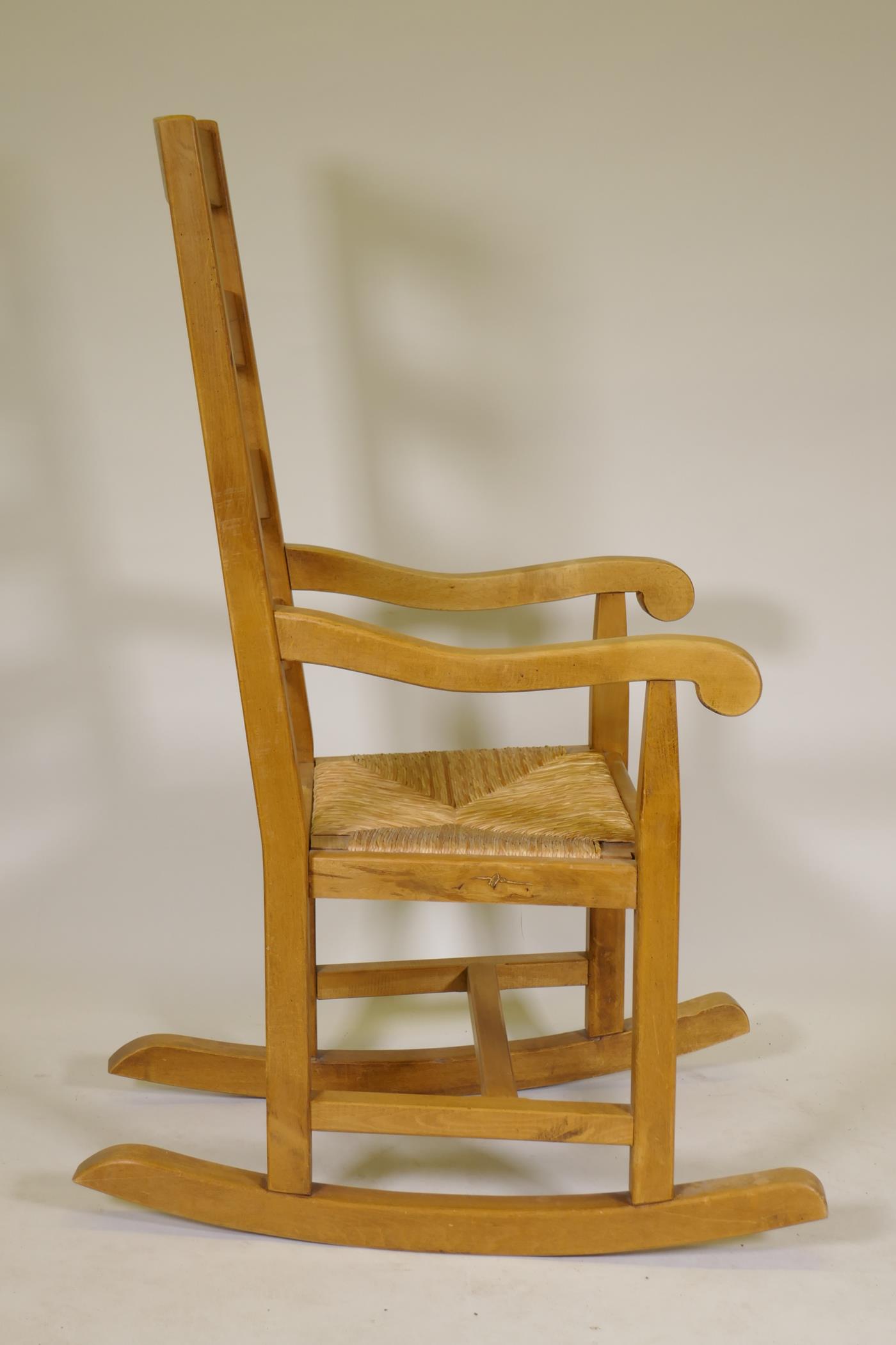 A beech wood ladderback rocking chair with rush seat - Image 4 of 4