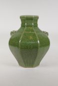 A Chinese olive green crackle glazed song style porcelain vase with two iron mask handles and