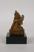 A Sino Tibetan gilt bronze figure of Buddha, on a display stand, 3" high