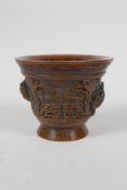 A Chinese faux horn libation cup with raised kylin decoration, impressed mark to base, 4" diameter